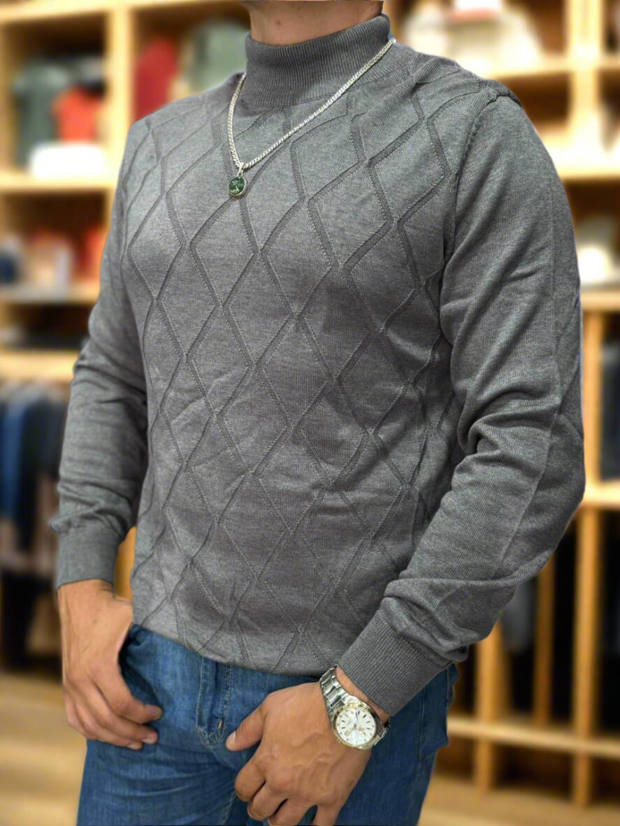 Person wearing a gray patterned sweater with a blurred background