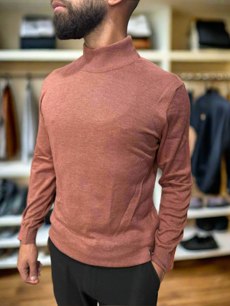 Man wearing a brown turtleneck sweater in a clothing store.