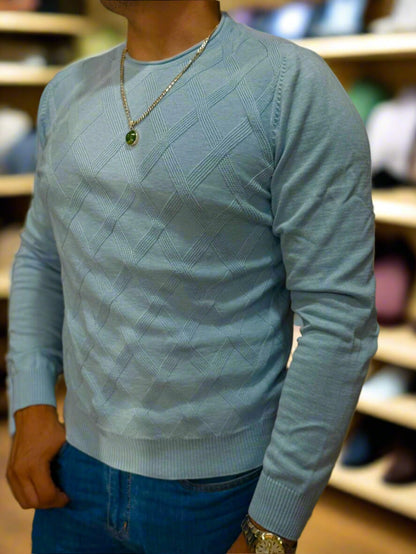 Light blue sweater worn by a person with a blurred background